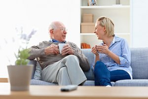 Man and woman sitting on couch together and talking